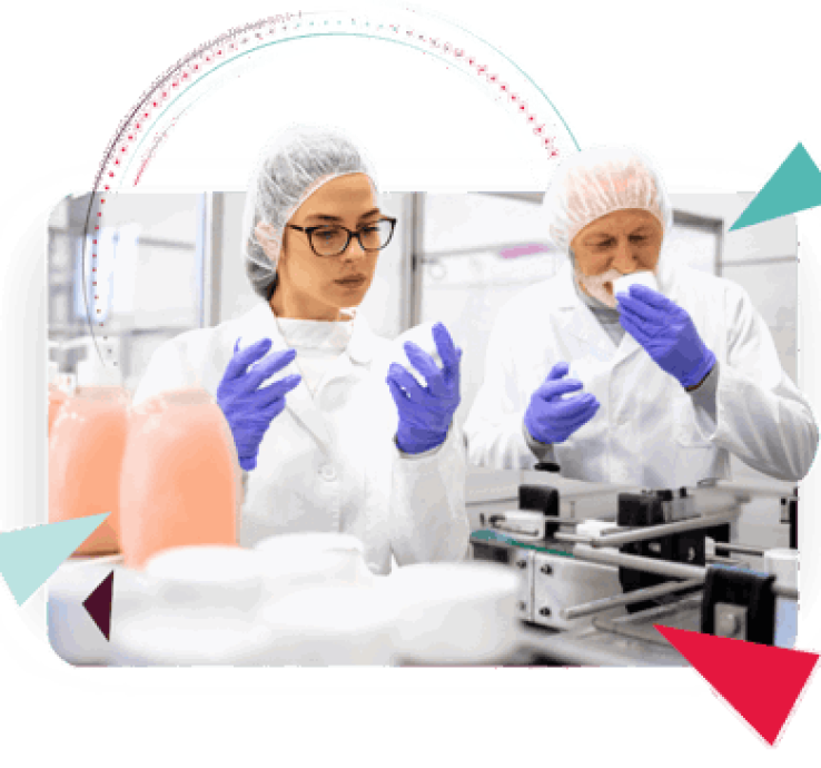 Two individuals in sterile lab attire, a woman in glasses and a man, engaged in product inspection on a manufacturing line. The woman on the left, wearing blue gloves, intently observes items on the conveyor belt. To her right, the man holds a sample of the product to his nose as though smelling it. Jars of viscous fluid stand behind them. The scene suggests quality control in a cosmetic manufacturing environment and represents streamlining processes with ERP solutions.
