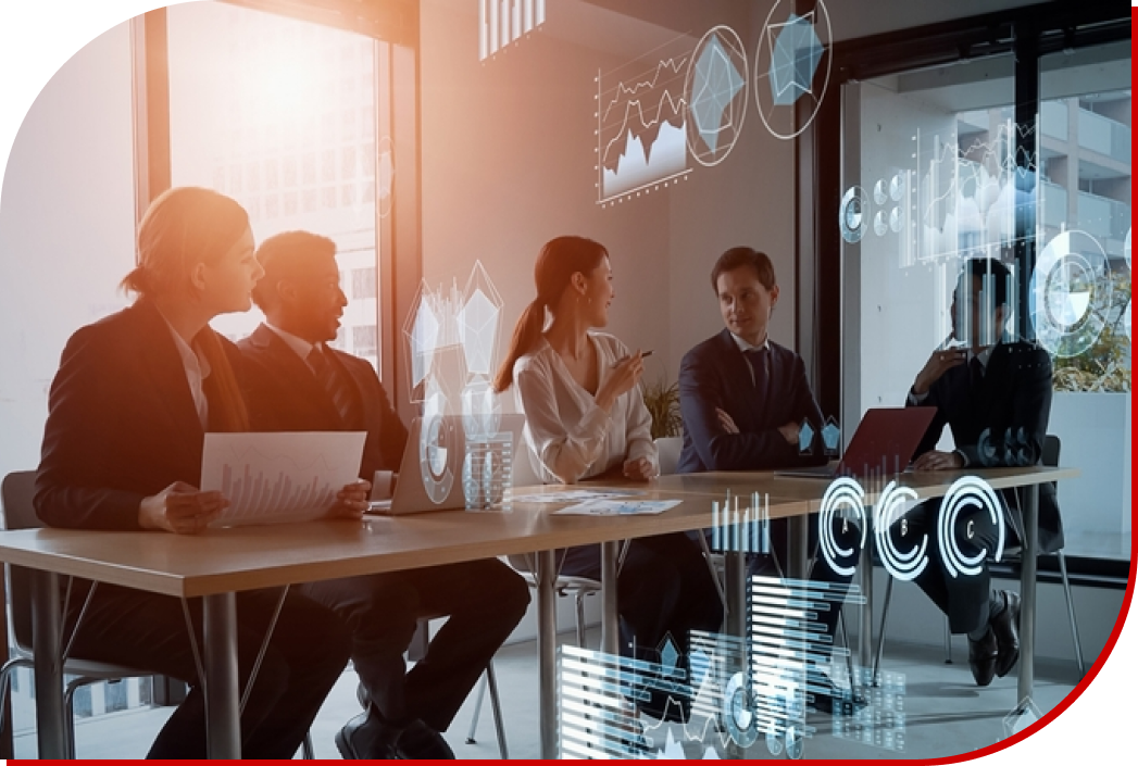 Four business professionals in a bright office setting, engaged in a meeting, with holographic data visualizations overlaid in the scene. The individuals, two women and two men, are seated around a table and displaying attentive expressions. Charts, graphs, and radial diagrams are digitally superimposed in the foreground, signifying data analysis and business strategy discussion. Natural light floods the room emphasizing a modern, spacious environment.