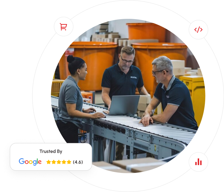 A group of people in a warehouse discussing a Google review related to eCommerce and manufacturing operations.